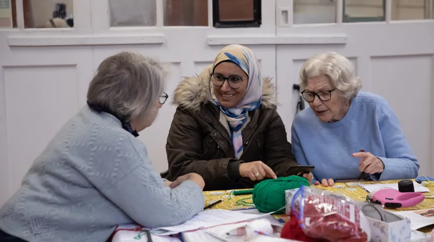 Service users at Mortlake Community Association London chat around a crafts table