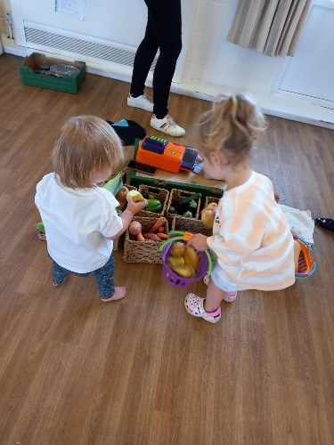 Two toddlers playing shops