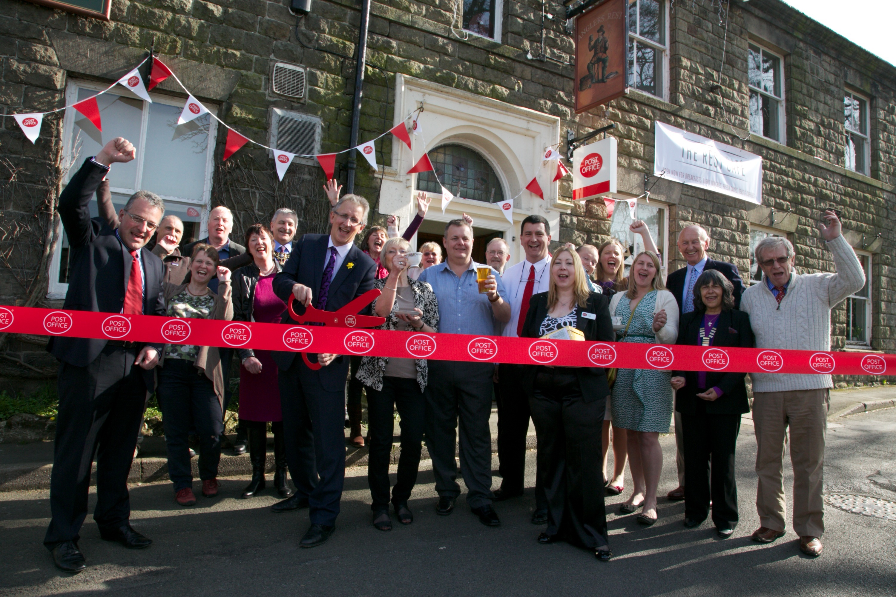 Local people celebrating the opening of a Post Office at The Anglers Rest, a community-owned pub in Bamford