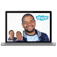 A computer screen showing people making a video call, with the Skype logo