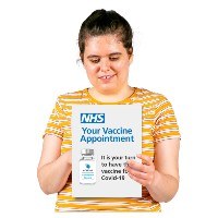 Woman holding paper, which says Your Vaccine Appointment