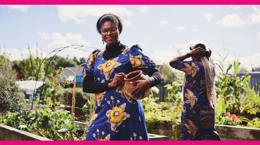 A woman in a vibrant dress in a community garden