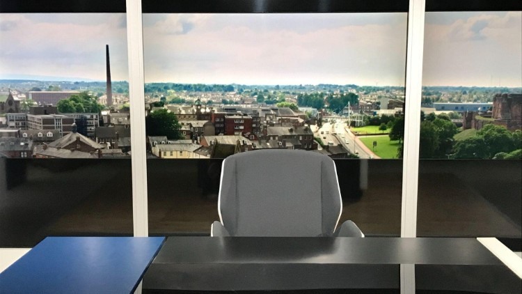 TV news desk with a view over Carlisle, showing Carlisle Castle and the tower of Dixon’s Chimney