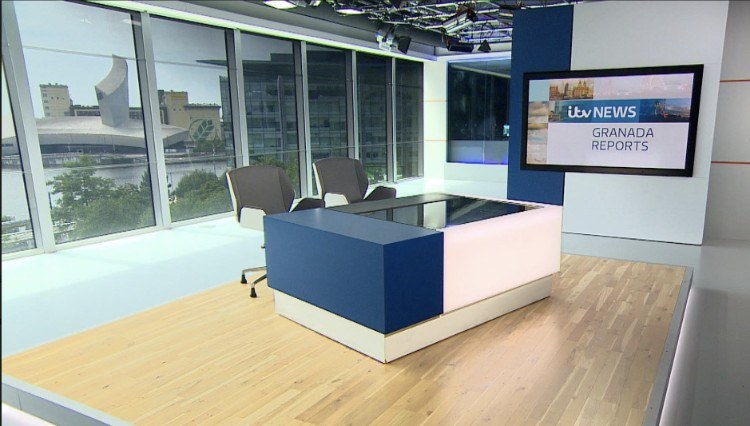TV news studio with view over the water of Manchester’s Salford Quays, showing the Imperial War Museum