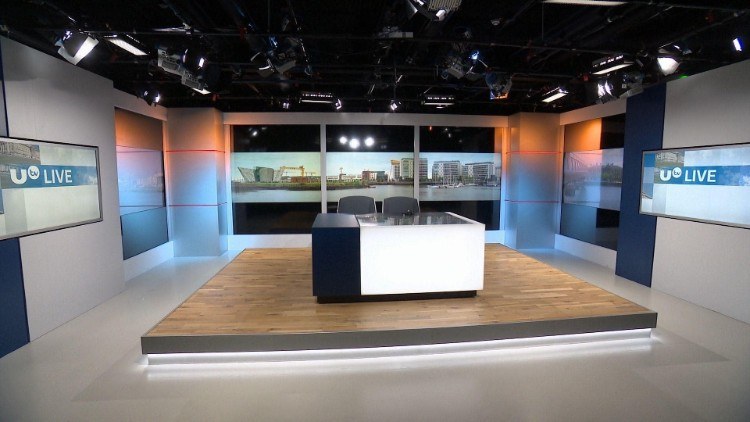 TV news studio with a view over the water of Belfast Docks, the Titanic Belfast museum and cranes