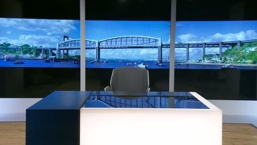 TV news studio with a view over water towards the Royal Albert Bridge in Plymouth