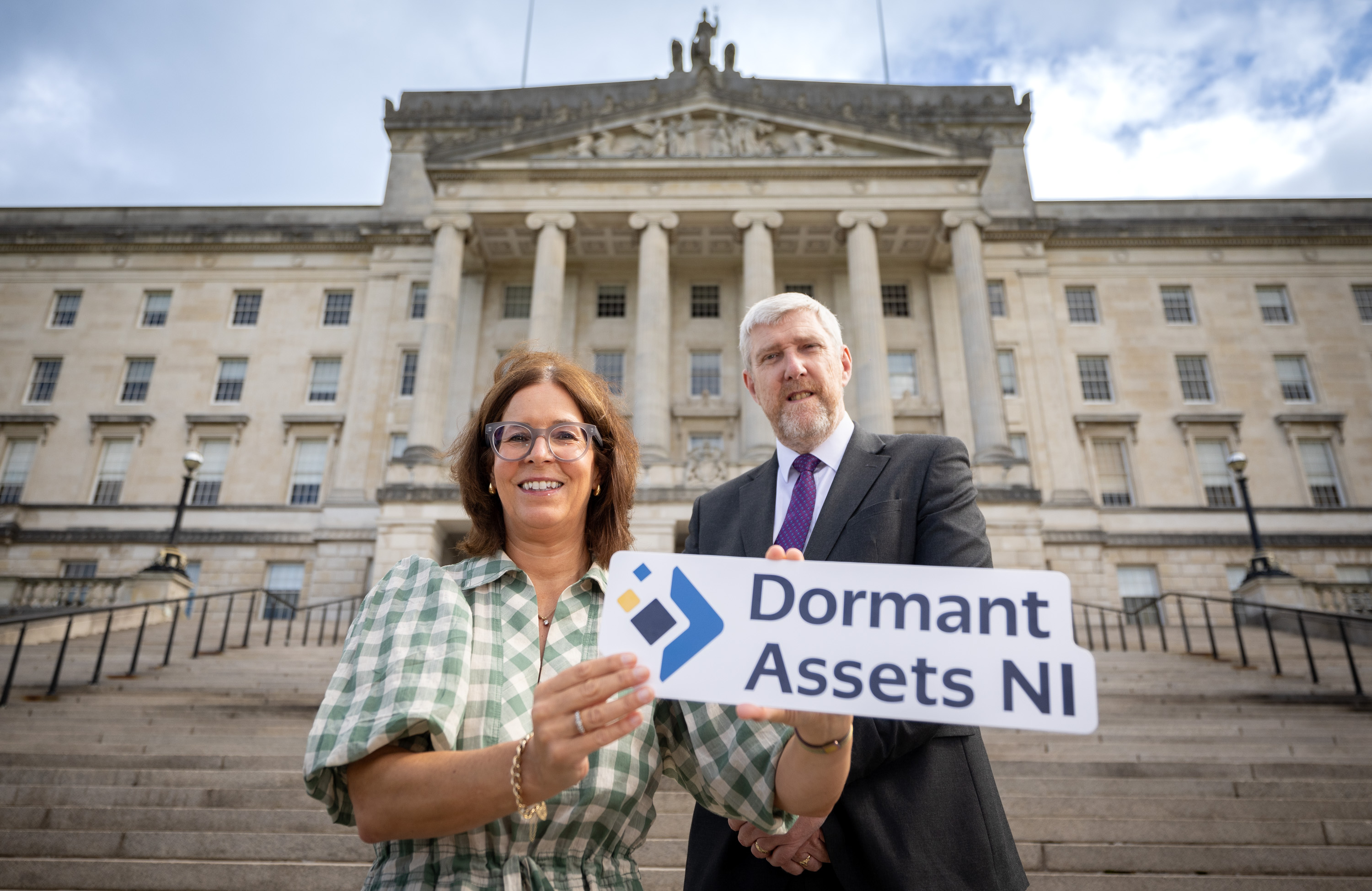 Alison Fraser, Senior Head of Funding in NI and John O'Dowd, NI Finance Minister, outside Stormont Buildings